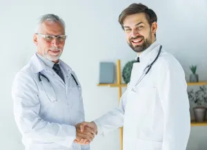 Doctors Shaking Hands Looking Camera Low